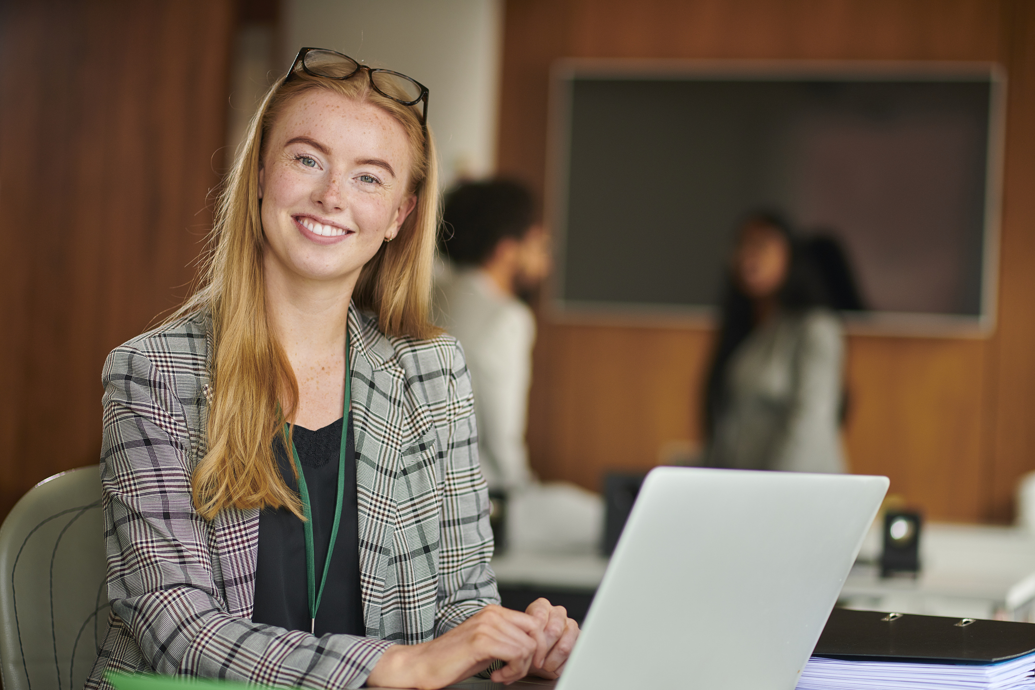 Smiling woman working on laptop in office