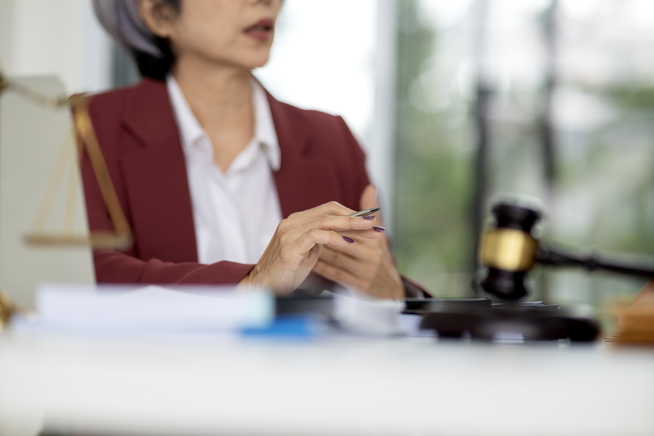 Lawyer at desk with gavel and scales