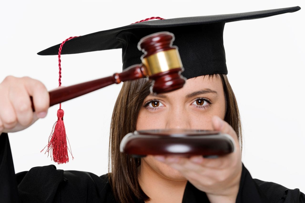 Woman in graduation attire with gavel
